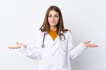 Young woman over isolated background wearing a doctor gown and having doubts