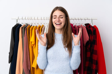 Young woman in a clothing store laughing