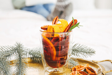 Glass cup of tasty mulled wine on tray