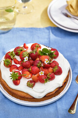 Pie with cream and strawberries on a summer background. . Homemade summer dessert.