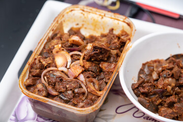 A picture of a locally prepared dish made up of spicy peppered goat known as Asun