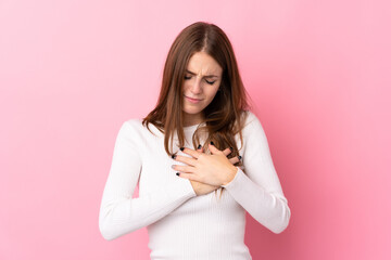 Young woman over isolated pink background having a pain in the heart
