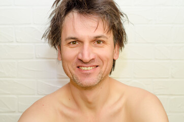 Emotional crazy caucasian man with bristles and shaggy hair, without closing, smiling happily on...