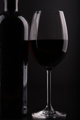 Naklejka na ściany i meble closeup wine bottle and glass with black background