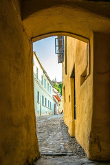 Ancient medieval buildings and narrow streets of Sighisoara city in Transylvania, Romania