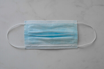 Medical blue white mask on white table background