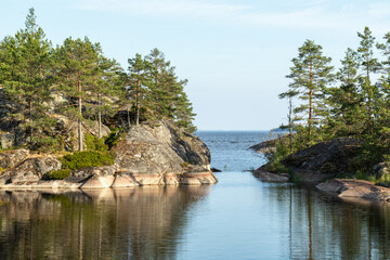 beautiful landscape with natural green plants and trees, rocks, mountain and pond, river in Karelia, Russia