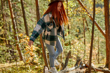 young fit hiking female try to climb mountains, go through the forest, enjoy travelling, trekking