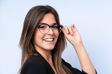 Teenager Brazilian girl with glasses over isolated background