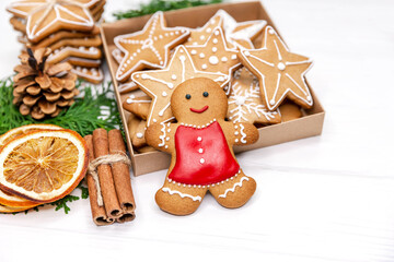 Tasty gingerbread cookie man and box of christmas cookies. Baking