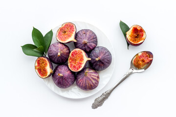 Fresh figs in on a plate with green leaves. Top view