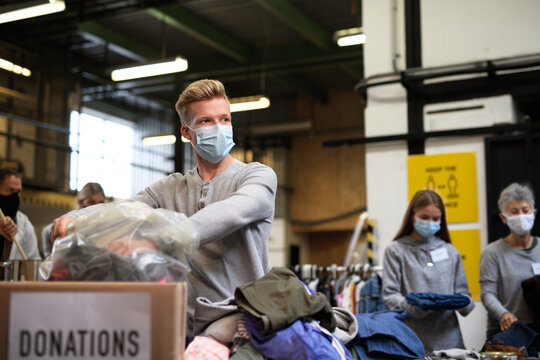 Volunteers sorting out donated clothes in community charity donation center