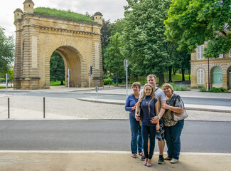 A group of Mature tourists walk through the streets of city