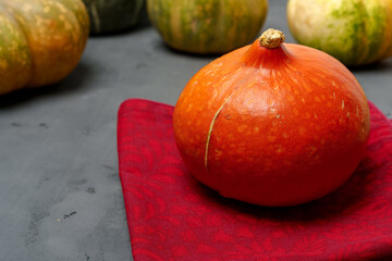 Close up photo of pumpkin on dark cooking table
