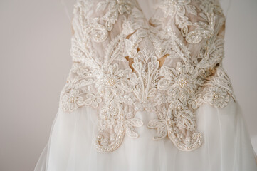 Fashionable beautiful classic lace silk brides dress in room. morning preparation wedding concept. vintage gown.