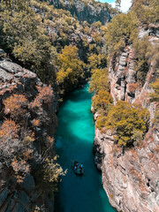 Ride a boat on the river that flows through the mountains. Ride a boat valley, canyon landspace.