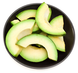 fresh sliced avocado in black bowl isolated on white background. full depth of field.