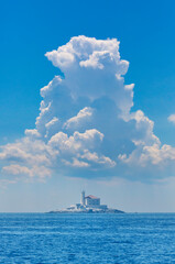 Obraz premium large cumulonimbus over the lighthouse, adriatic sea, Croatia