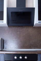 Kitchen interior, with hood and dark backsplash for kitchen units