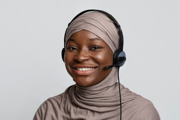 Portrait of black muslim call center operator lady in hijab and headset