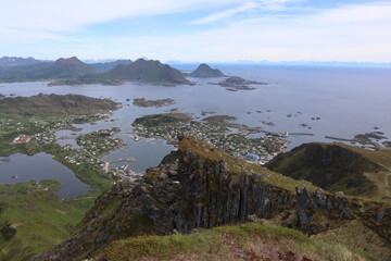 , / Norway - June 20 2019: View from mountain Nonstinden onto village Ballstad