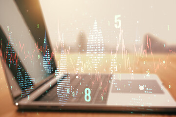 Double exposure of abstract creative financial chart on modern laptop background, research and strategy concept