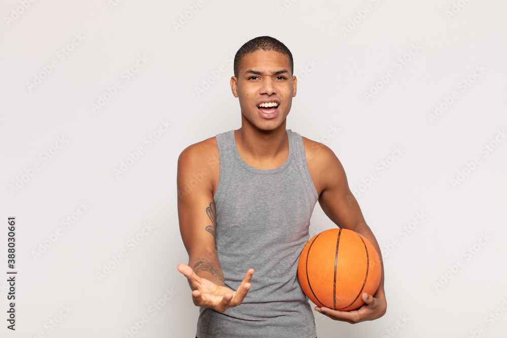 Canvas Prints young black man looking angry, annoyed and frustrated screaming wtf or what’s wrong with you