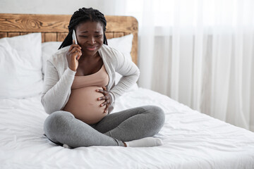 African American Pregnant Lady Feeling Pain In Belly, Calling Doctor On Cellphone