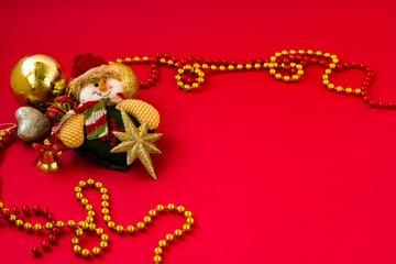 Red background with christmas ornaments and product can be placed angle