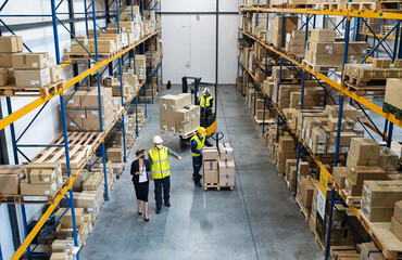 Top view of group of workers with manager working indoors in warehouse, coronavirus concept.