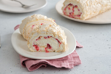 Meringue roll cake with cream, raspberries. Roulade, summer dessert. Confectionery, menu. Close up