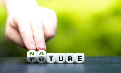 Hand turns dice and changes the word "future" to "nature".