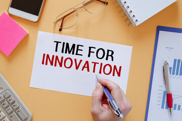 Paper with text TIME TO INNOVATION near office supplies.