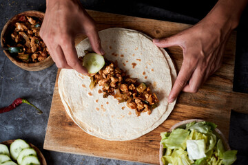 man preparing a durum or a burrito