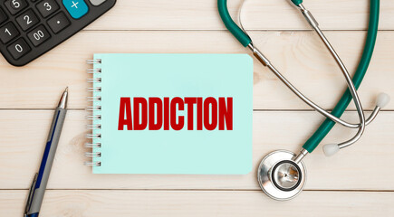 Notepad with text ADDICTION and stethoscope