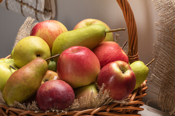 apples and pears of different varieties in a basket close-up. Fruit harvest

