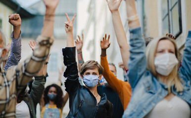 Group of people activists protesting on streets, strike and demonstration concept.