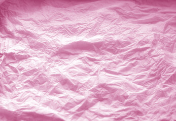 Crumpled paper background in pink color.