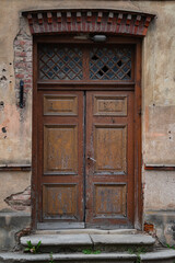 Fototapeta na wymiar A well-preserved wooden door in an old house in Cesis, Latvia.