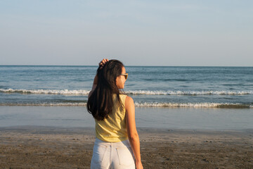 Fototapeta na wymiar Young teenage woman girl on the seashore beach coast holiday vacation for optimistic relaxation lifestyle
