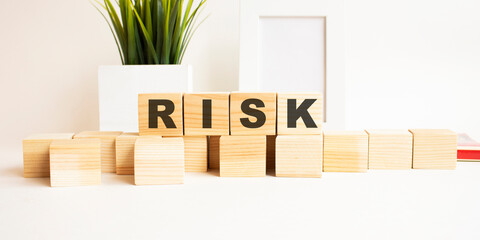 Wooden cubes with letters on a white table. White background.