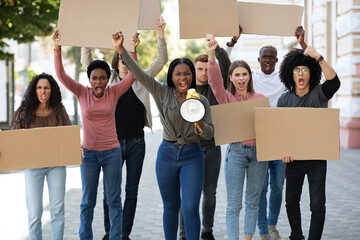 International demonstrators striking on the street, holding megaphone and placards