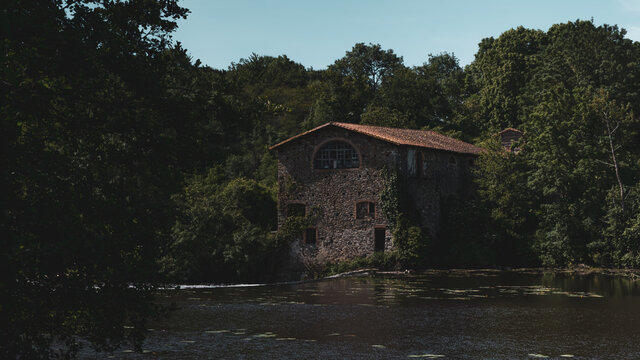 Clisson, France - 05/08/2020: House of clisson fortified famous city of France. House by the river in Clisson France. Old water mill by the river.