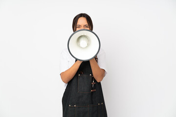 Young hairdresser woman isolated on white background shouting through a megaphone