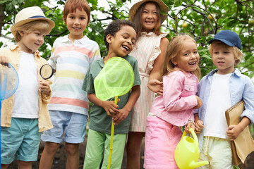 happy multi-ethnic group of children have fun, walk in garden or greenhouse, get to know the world...