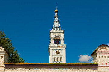 Fototapeta na wymiar Bell tower with the clock tower of the Spaso-Blakhernsky nunnery in the village of Dedenevo, Dmitrovsky district, Moscow region (Russia)