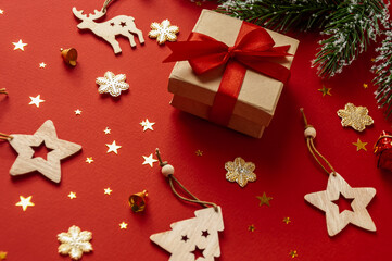 Wooden Christmas toys, gift on a red background.