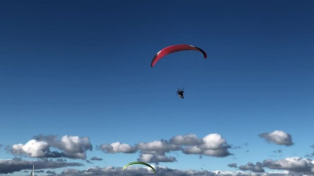 motorized hang glider landing on the beach