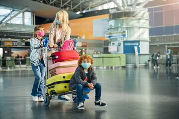 Boy sitting on a cart with colourful suitcases