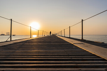 Long pier for ships at sea at sunset.Magnificent sunset landscape with a view of the Black sea.